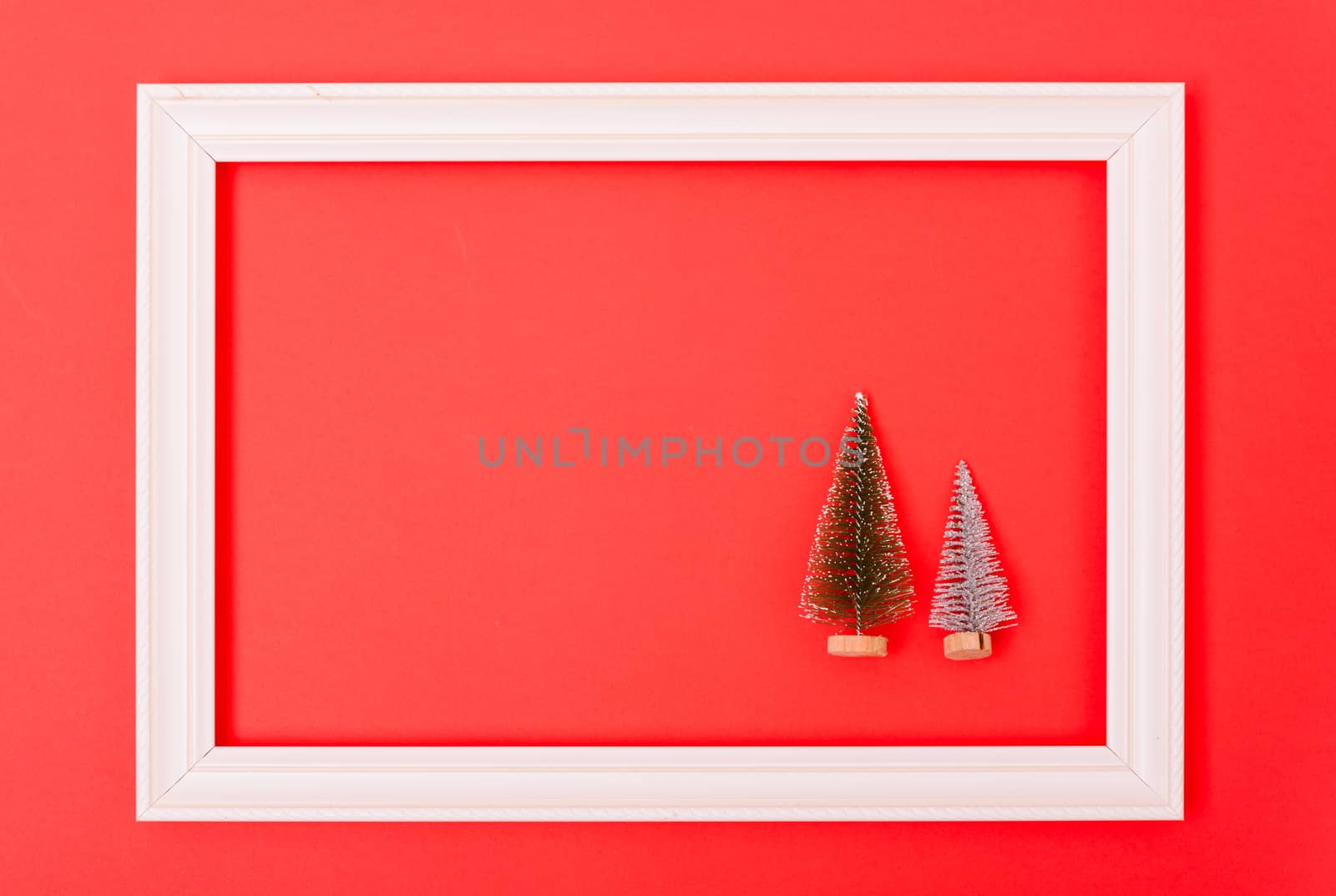 New Year, Christmas Xmas holiday composition, Top view both green fir tree branch in frame on red background with copy space