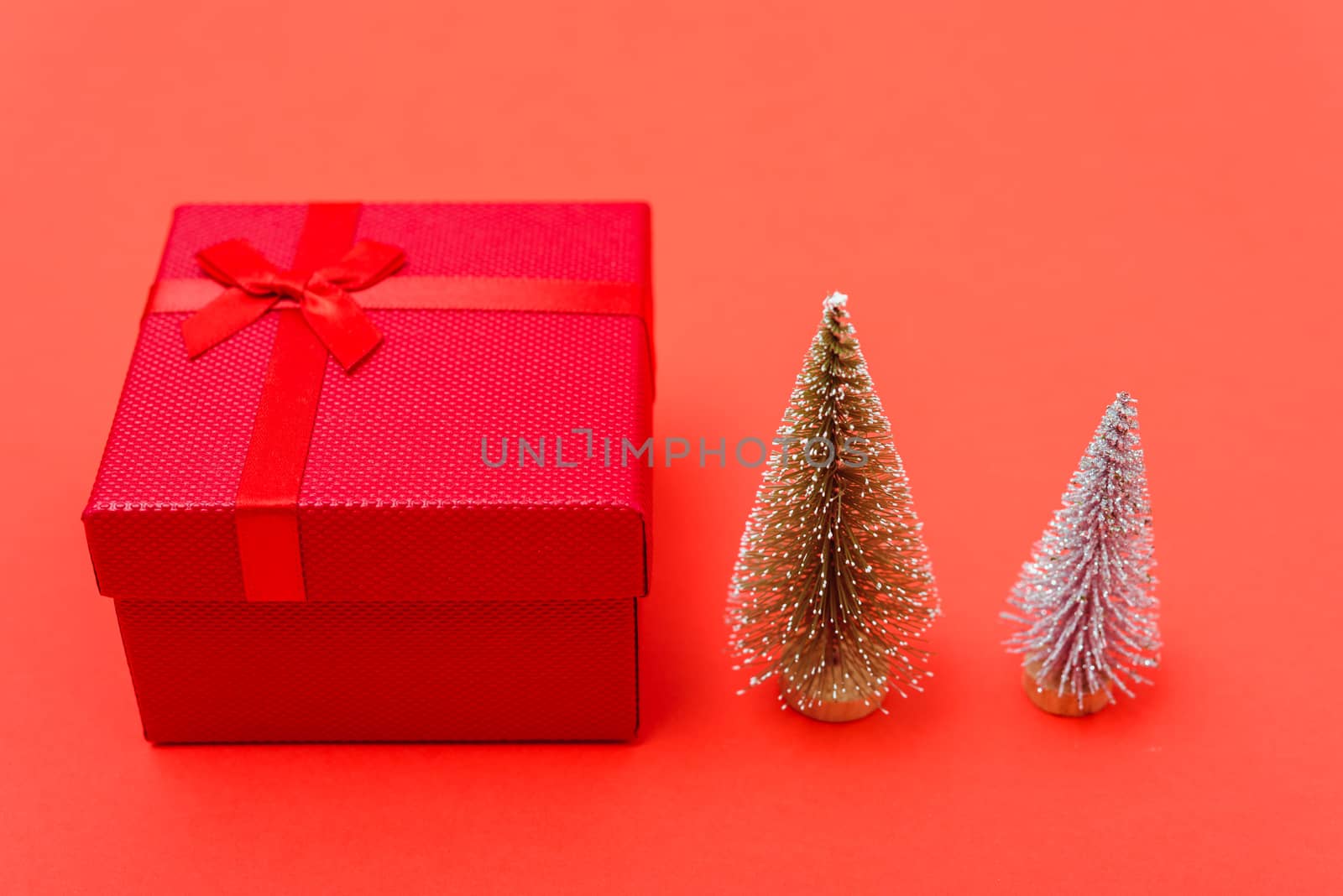 New Year, Christmas Xmas holiday composition, Top view red gift box and green fir tree branch on red background