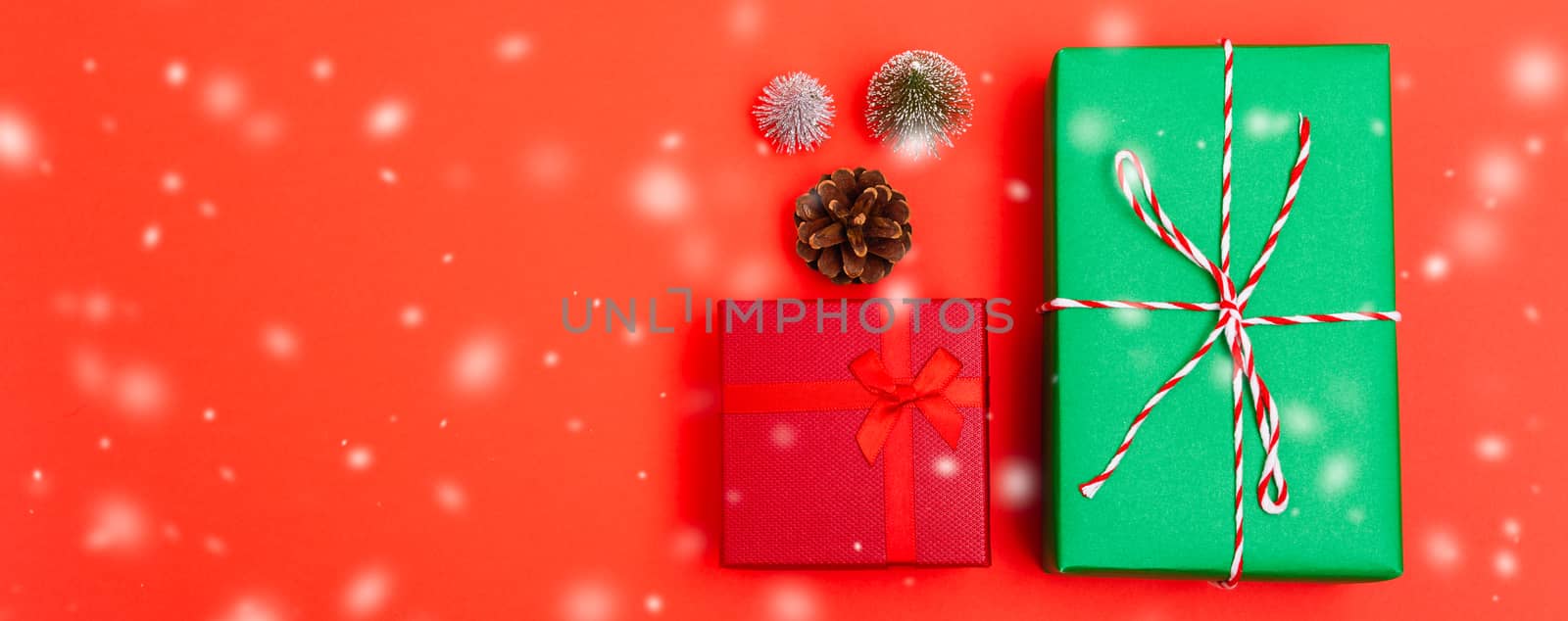 New Year, Christmas Xmas holiday composition, Top view green and red gift box and green fir tree branch on red background with copy space