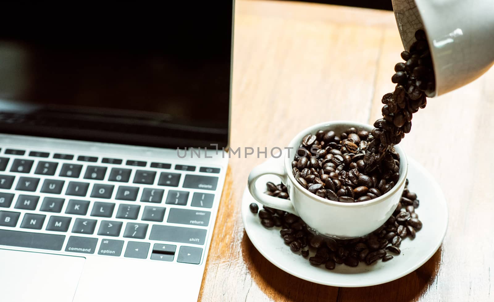 Workplace business laptop computer have coffee drop into cup, in coffee shop