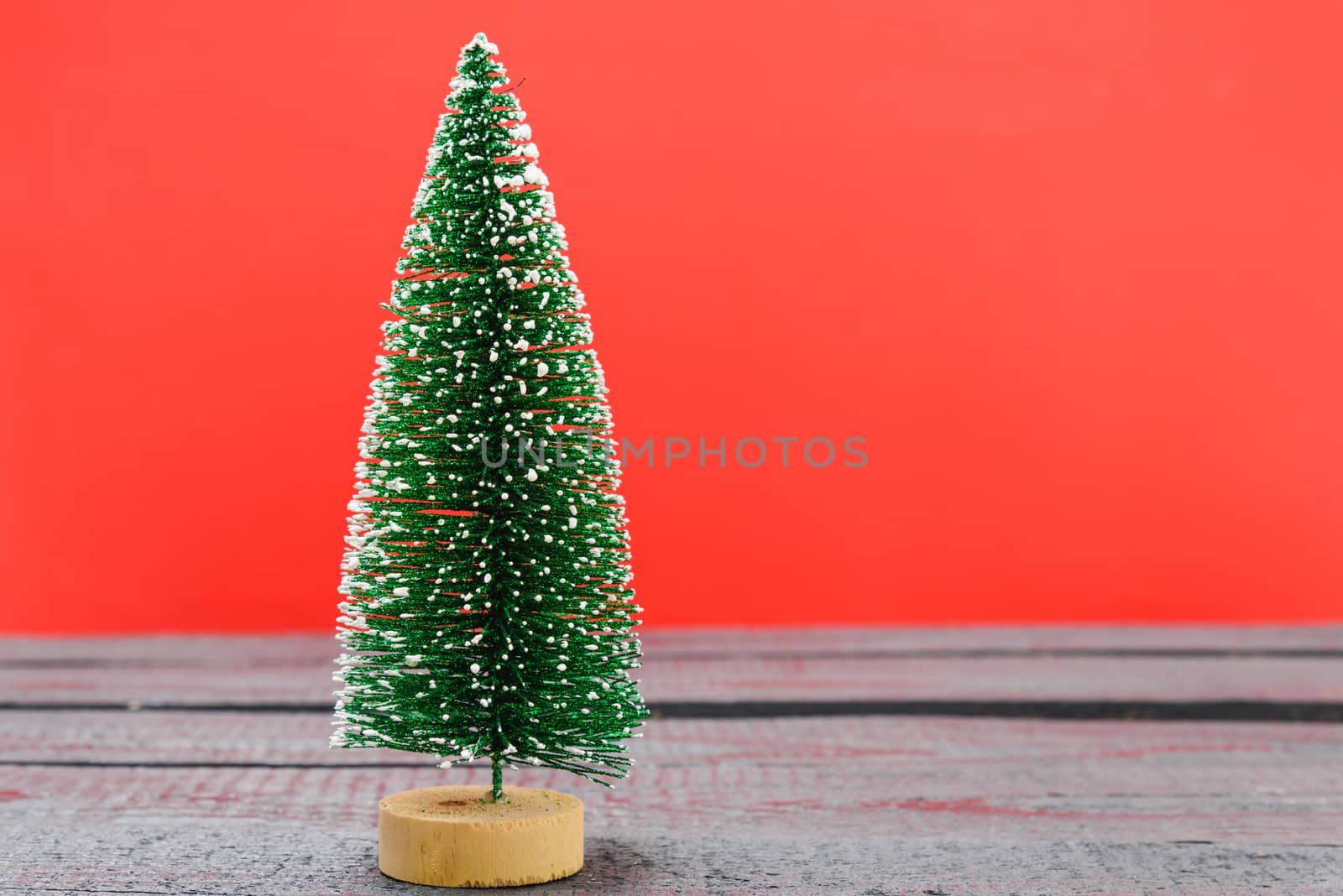Christmas composition decorations, minimal green fir tree branches with snow on red background. Merry Christmas concept. Copy space for text