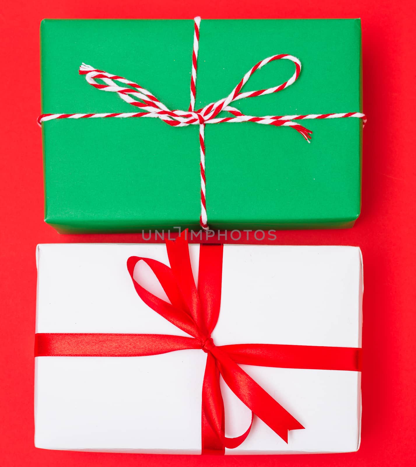 Happy New Year and Christmas 2020 day, top view Xmas white and green gift boxes on red background with copy space for your text