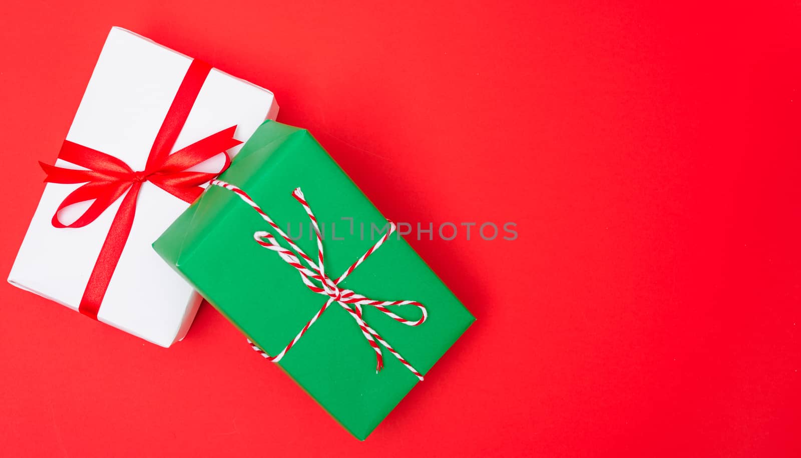 Happy New Year and Christmas 2020 day, top view Xmas white and green gift boxes on red background with copy space for your text