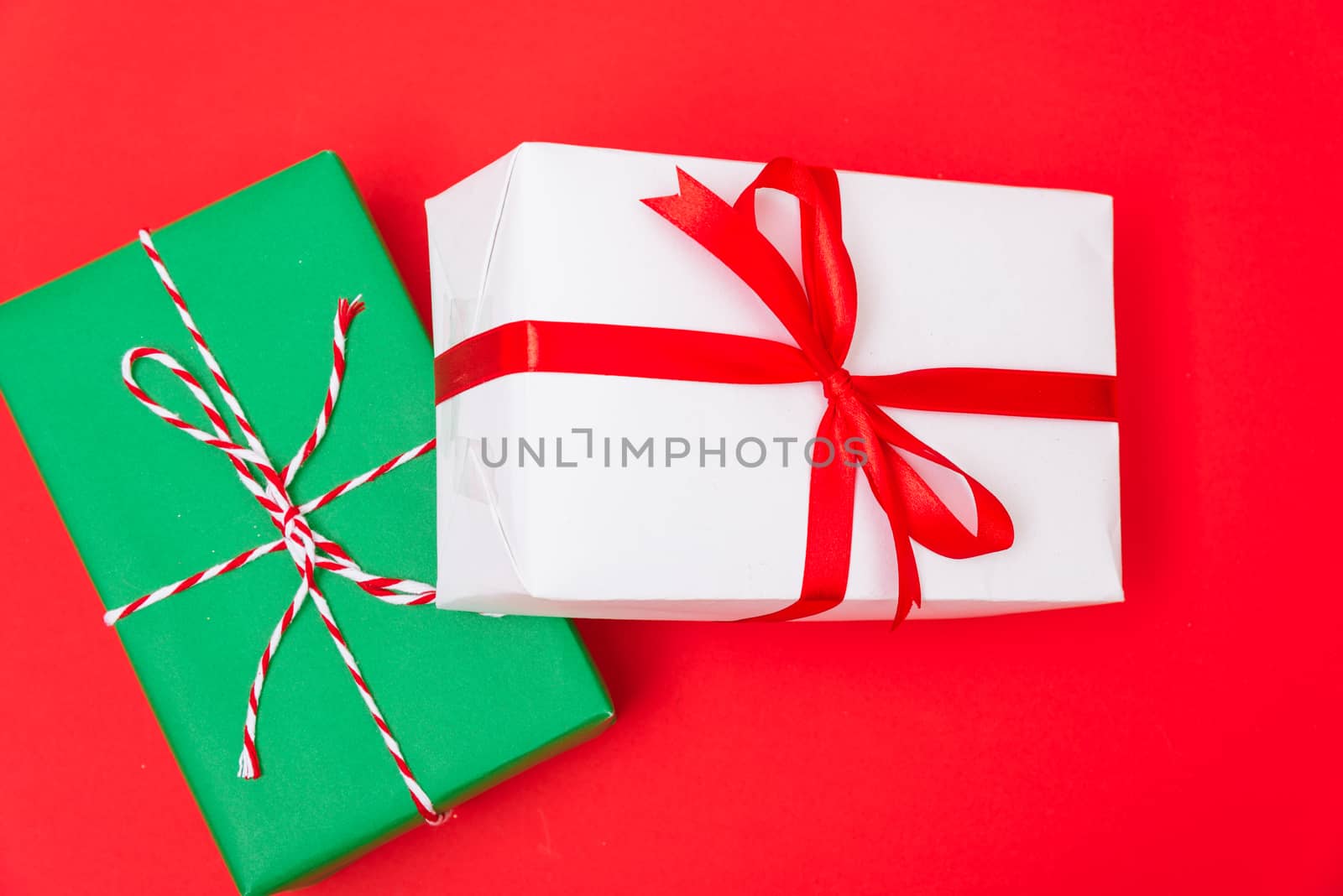 Happy New Year and Christmas 2020 day, top view Xmas white and green gift boxes on red background with copy space for your text