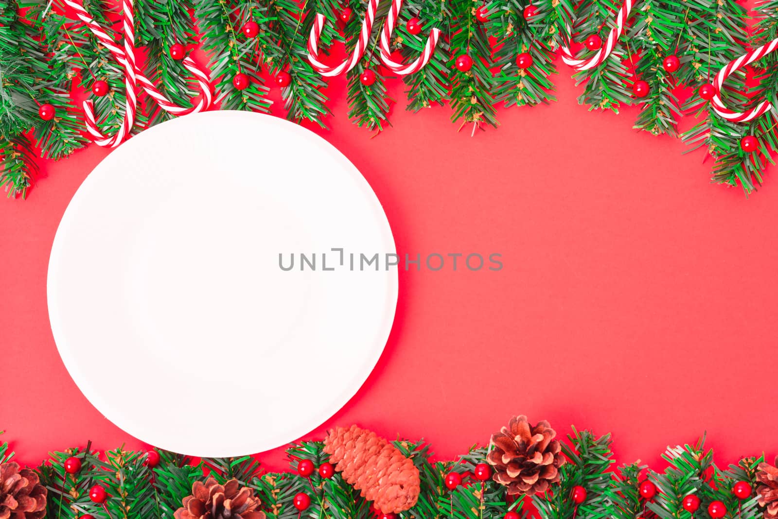 Happy New Year and Christmas day, top view flat lay composition decoration tree fir and white round on red background with copy space for your text