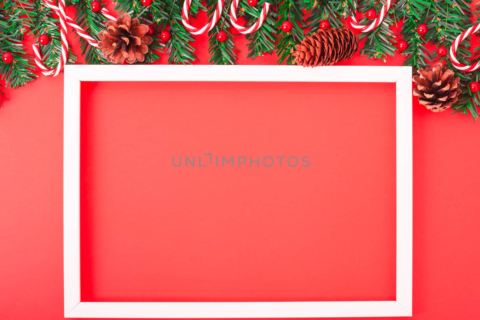 Happy New Year and Christmas day, top view flat lay composition decoration tree fir and photo frame on red background with copy space for your text
