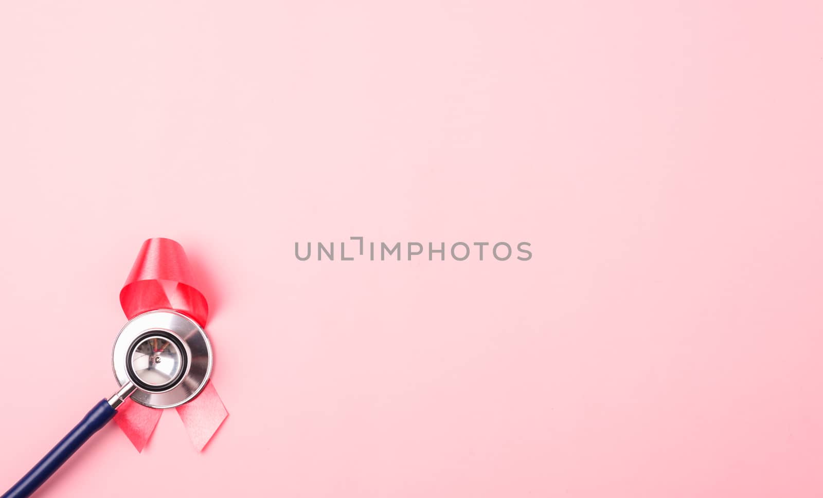 Breast Cancer Awareness Month Health concept, top view flat lay pink ribbon and stethoscope on pink background with copy space for your text