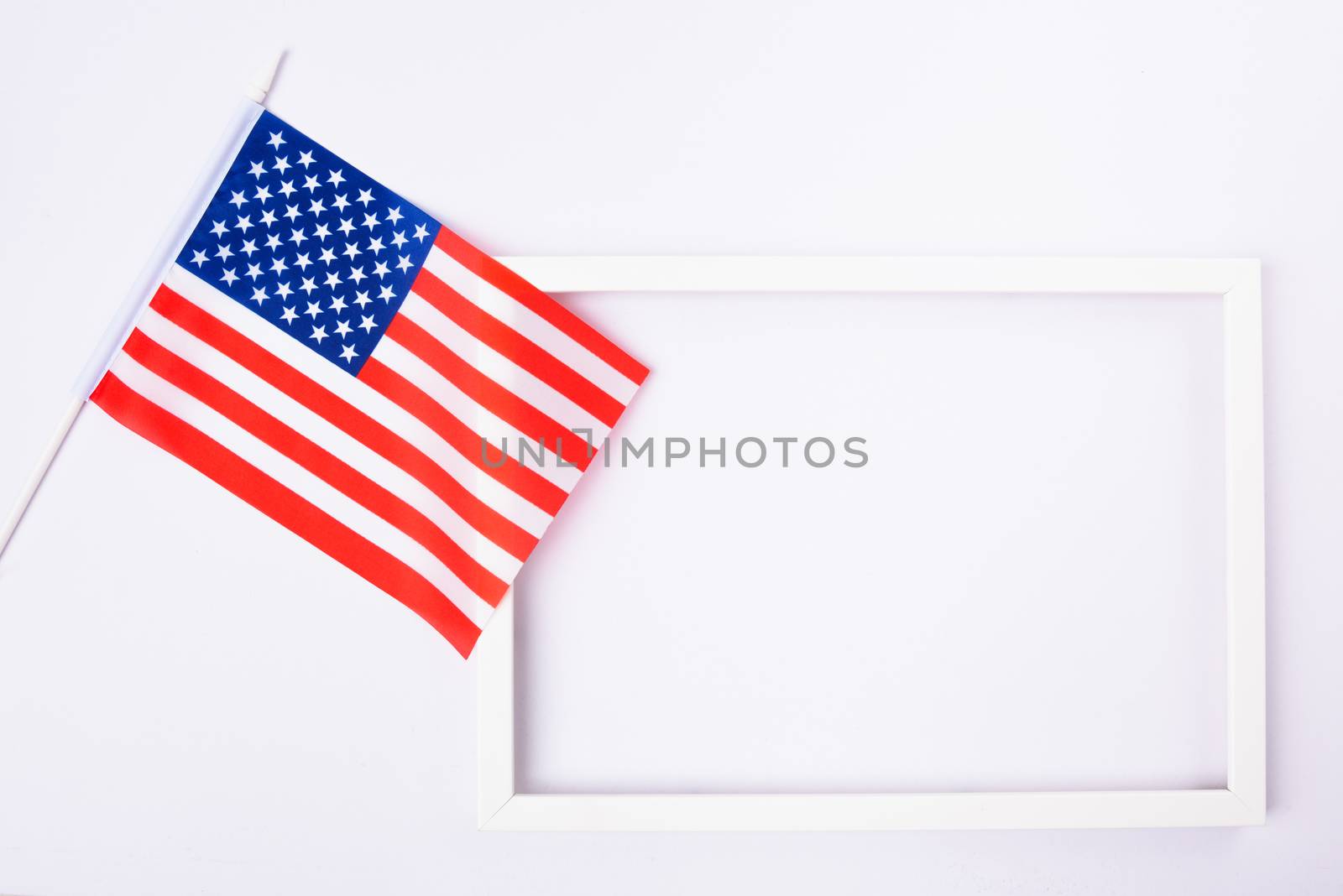 Martin luther king day, flat lay top view, American flag and photo frame on white background with copy space for your text