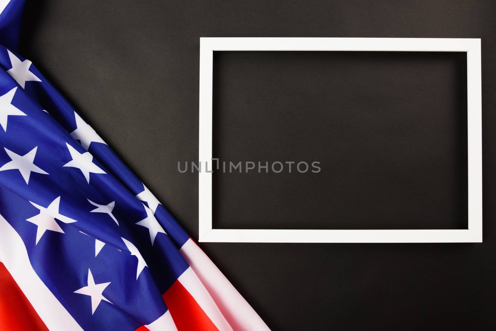 Martin luther king day, flat lay top view, American flag and photo frame on black background with copy space for your text