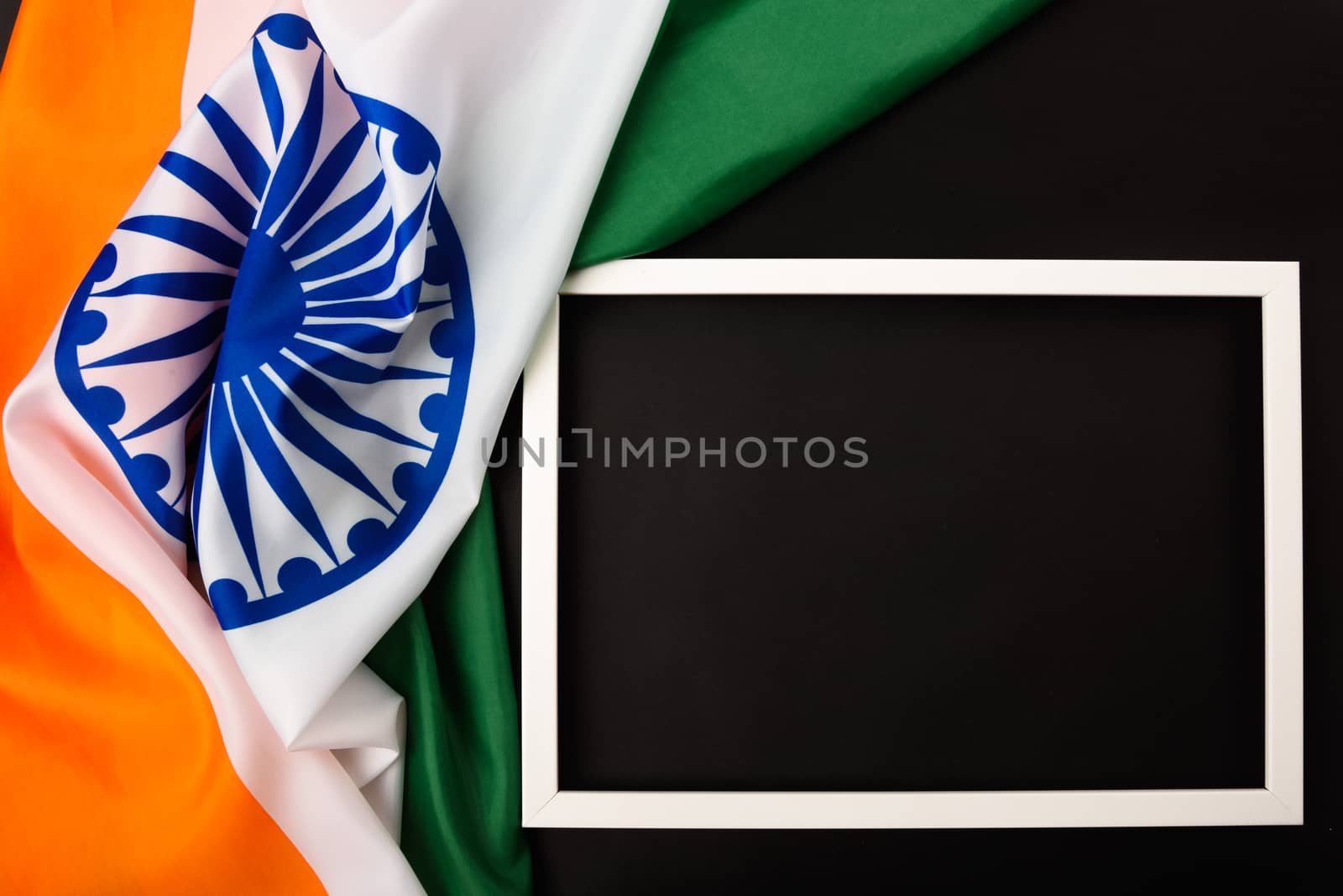 Indian republic day, flat lay top view, Indian flag and photo frame on black background with copy space for your text