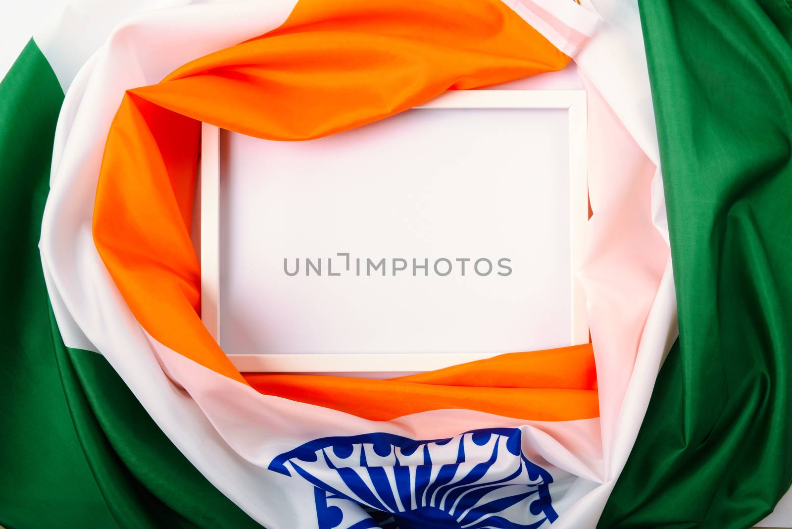 Indian republic day, flat lay top view, Indian tricolor flag and photo frame on white background with copy space for your text