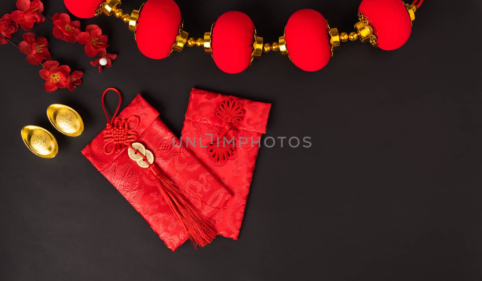 Chinese new year concept, flat lay top view, Happy Chinese new year with Red envelope and gold ingot (Character "FU" means fortune, blessing, wealth) on black background with copy space for your text