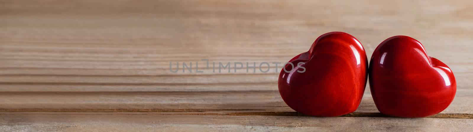 Two red wooden hearts symbol of love on wooden background, Saint Valentine Day celebration, copy space for text