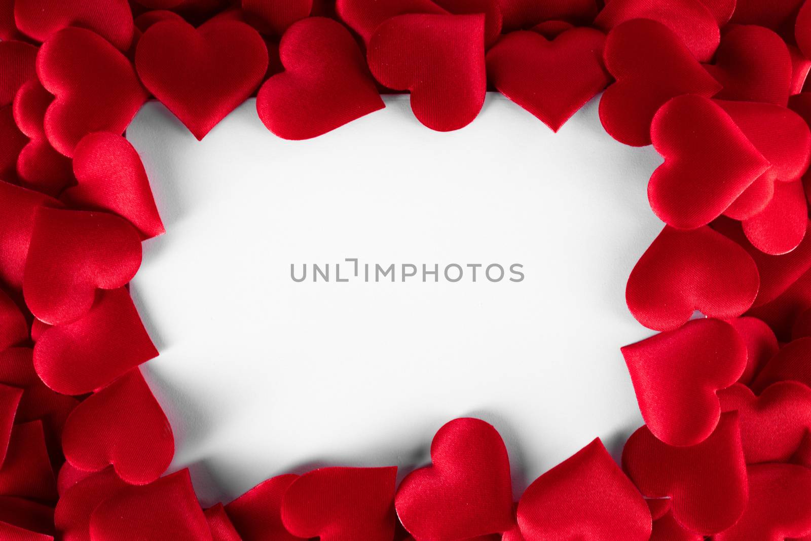 Valentine's day many red silk hearts background , border frame isolated on white with copy space, love concept