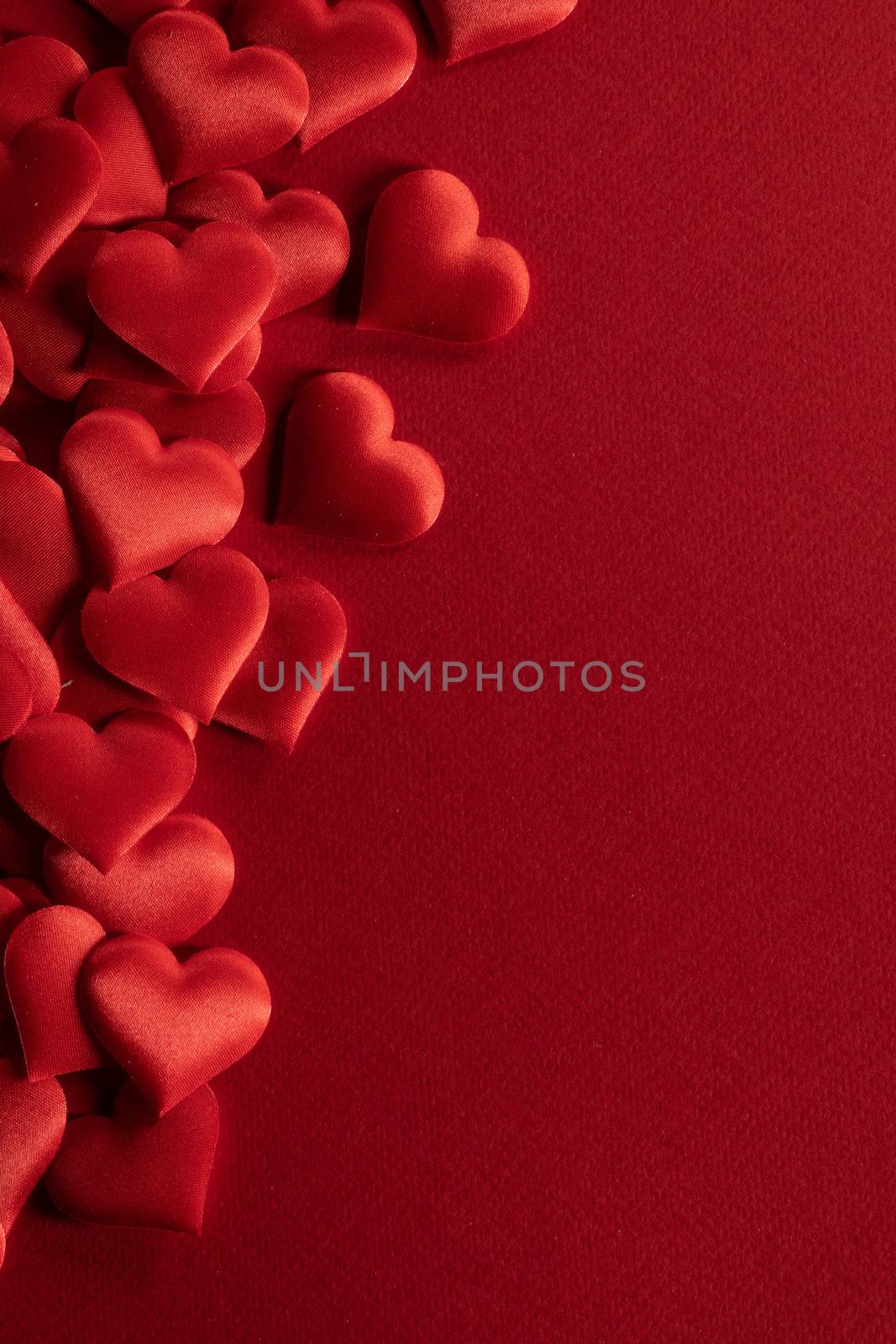Valentine's day many red silk hearts background , border frame on red with copy space, love concept