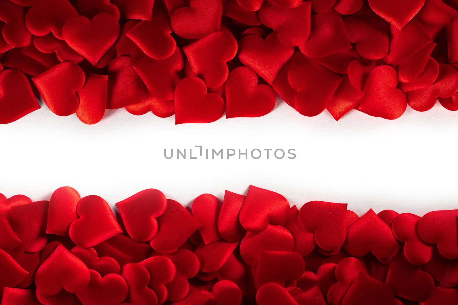 Valentine's day many red silk hearts background , border frame isolated on white with copy space, love concept
