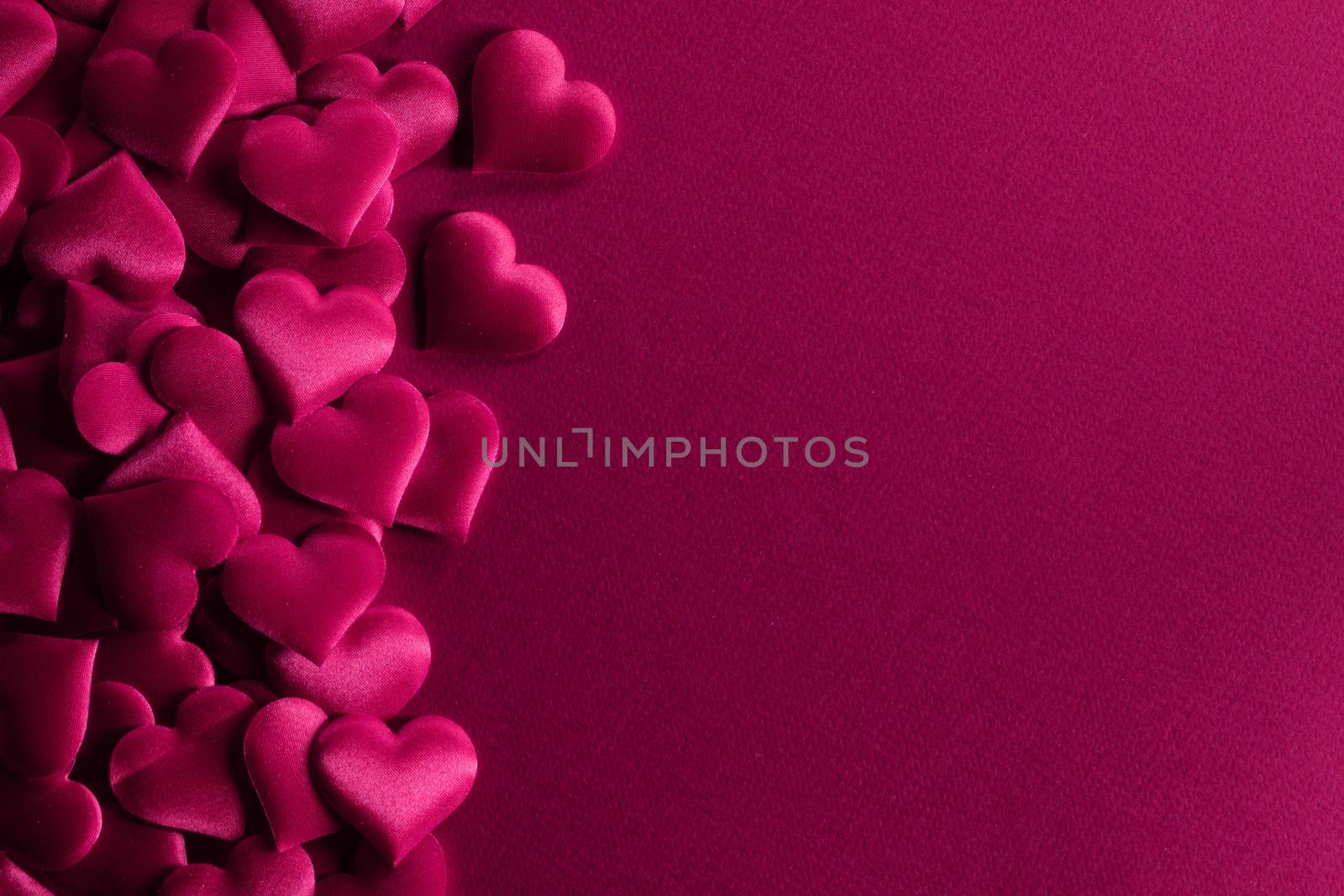 Valentine's day many red silk hearts background , border frame on red with copy space, love concept