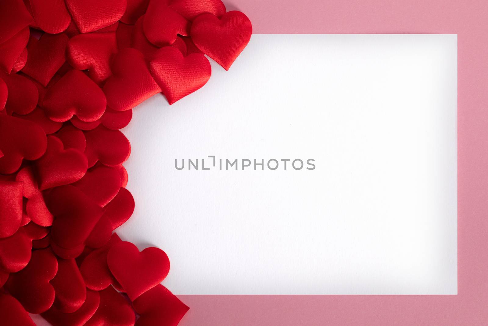 Valentine's day many red silk hearts background , border frame with white card with copy space, love concept