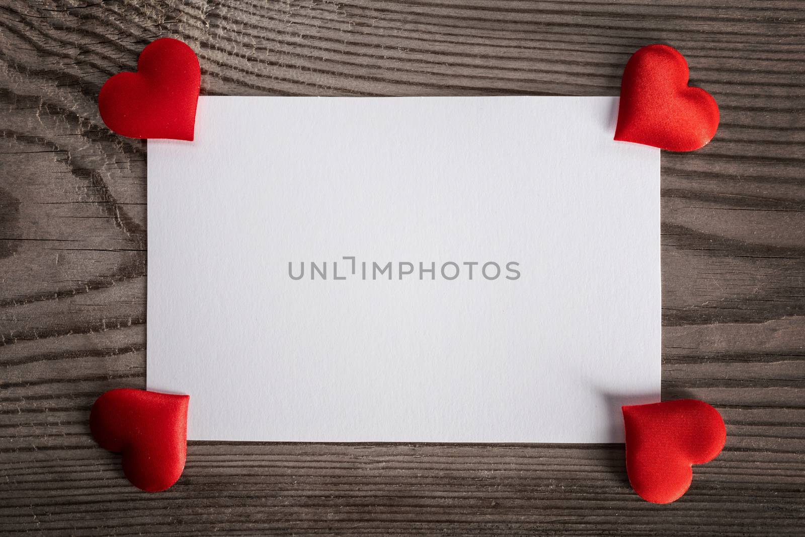 Valentine's day white blank paper greeting card and red silk hearts, background border frame with copy space, love concept