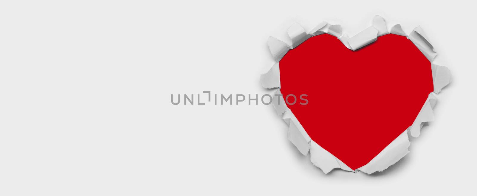 Torn white paper heart over red background with copy space for text, Valentine's day love concept
