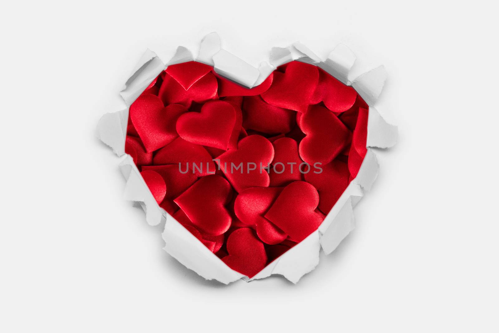 Torn white paper heart over red hearts background with copy space for text, Valentine's day love concept