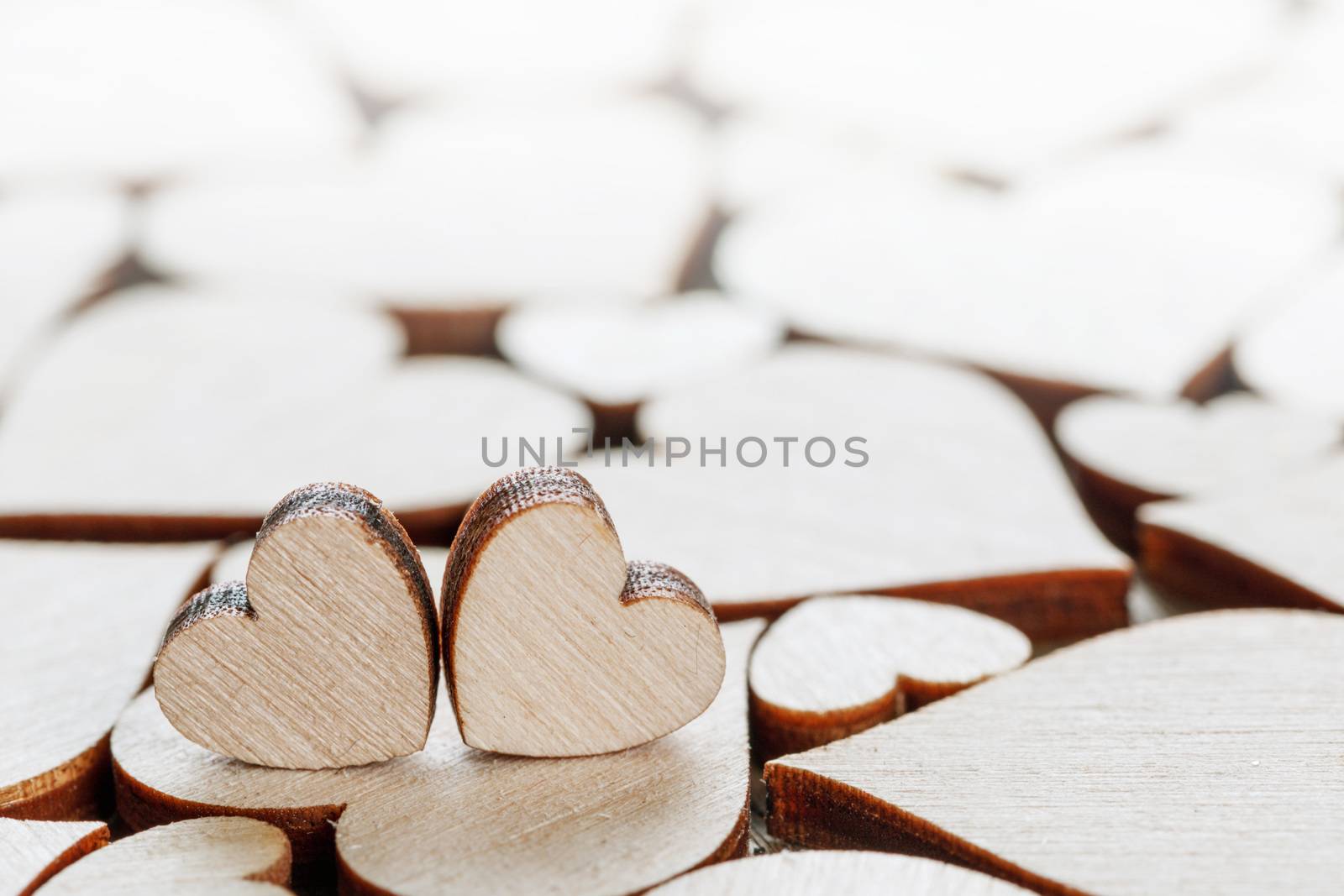Many wooden colorless hearts background