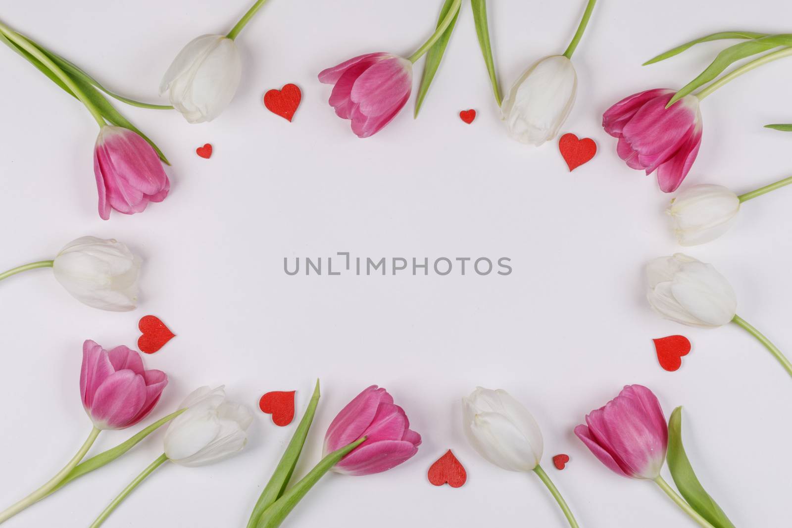 Frame made of colourful tulips and red hearts Valentines day background