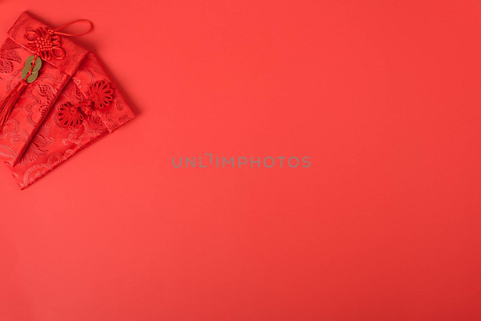 Chinese new year festival concept, flat lay top view, Happy Chinese new year with Red envelope (Character "FU" means fortune, blessing, wealth) on red background with copy space for your text