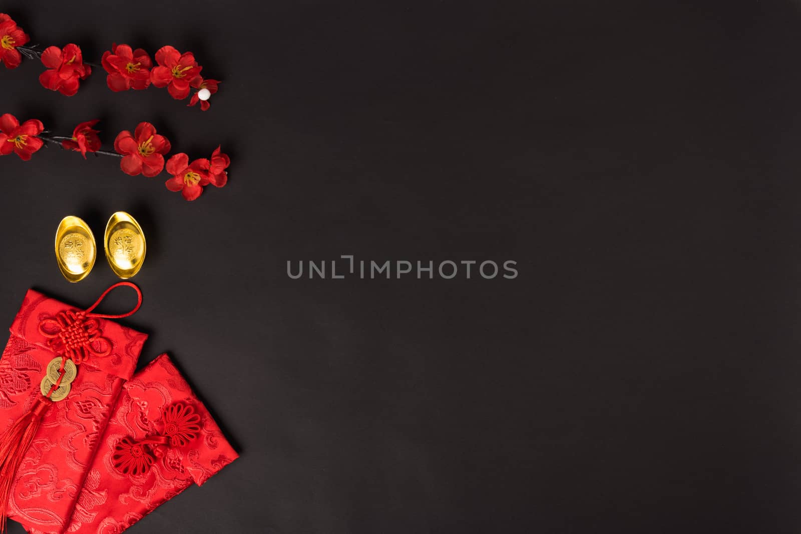 Chinese new year concept, flat lay top view, Happy Chinese new year with Red envelope and gold ingot (Character "FU" means fortune, blessing, wealth) on black background with copy space for your text