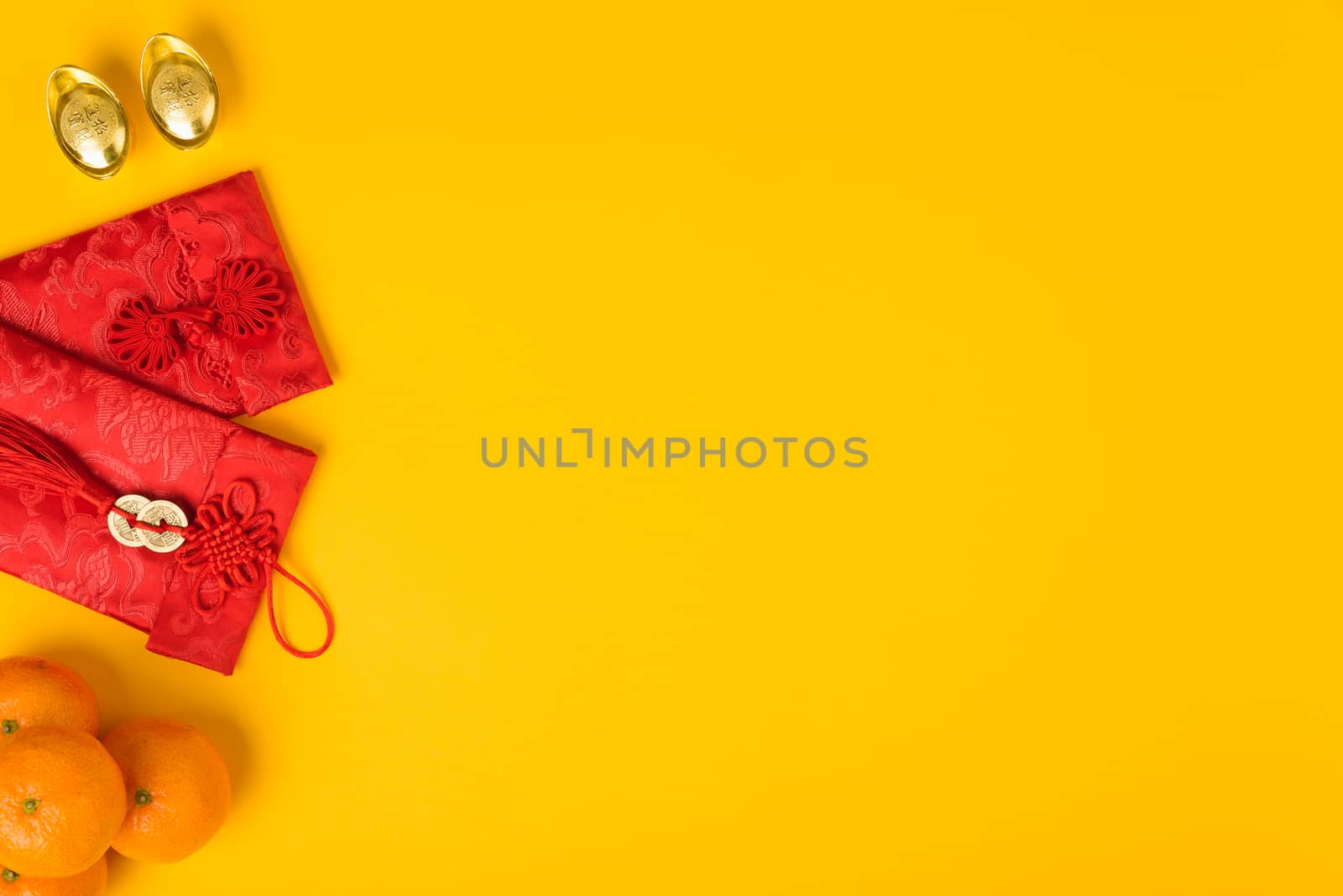 Chinese new year festival concept, flat lay top view, Happy Chinese new year with Red envelope and gold ingot (Character "FU" means fortune, blessing) on yellow background with copy space for text