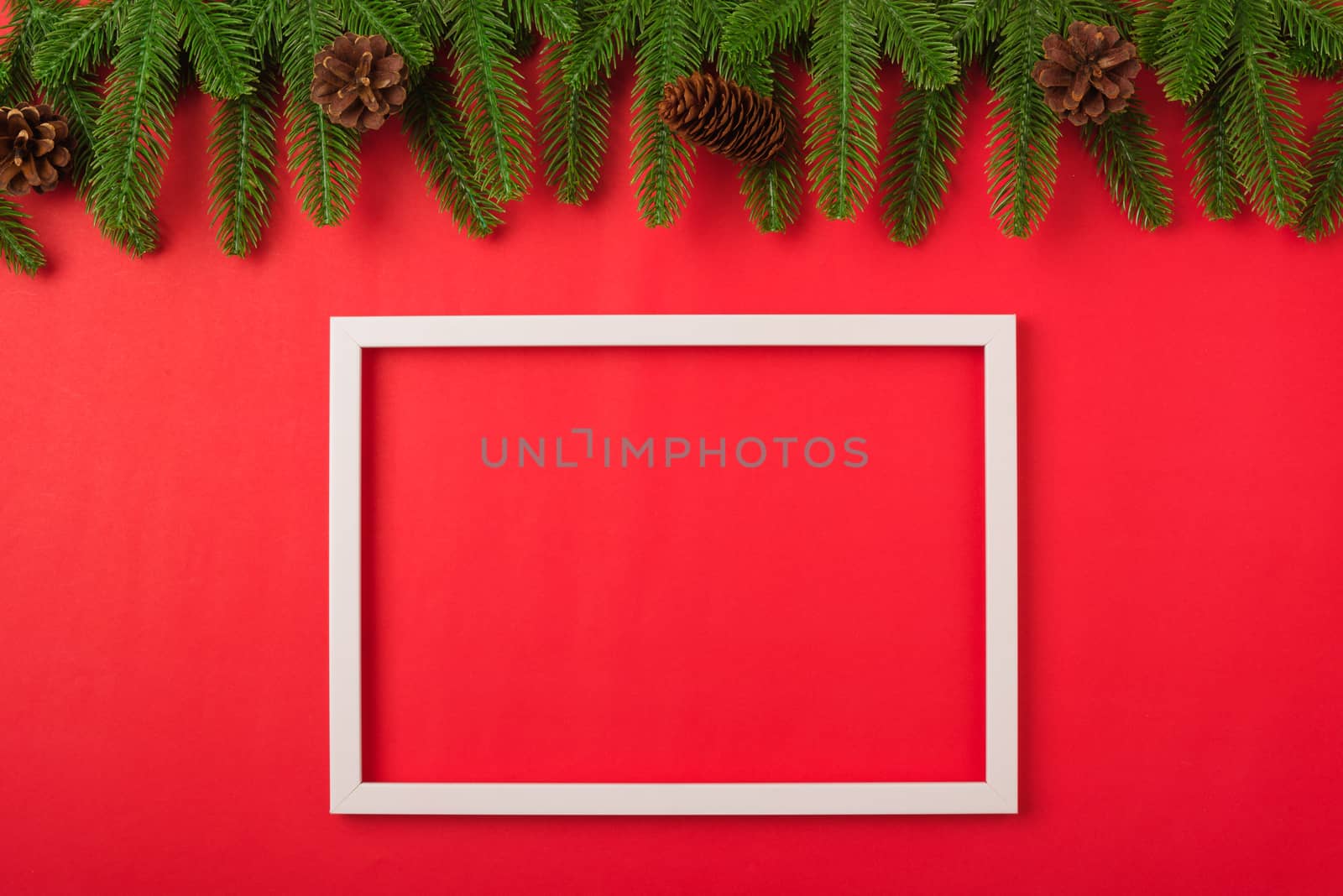 Happy new year or christmas day top view flat lay fir tree branches and decoration photo fram on red background with copy space for your text