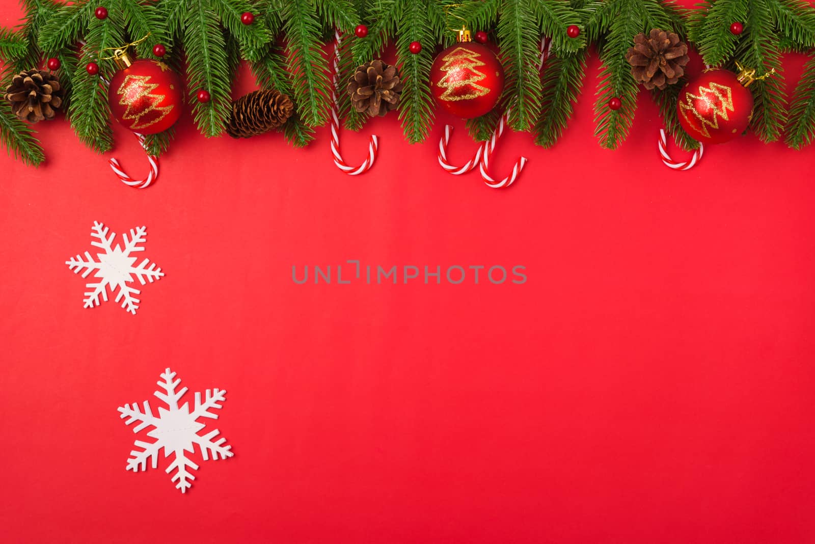 Happy new year or christmas day top view flat lay fir tree branches and decoration on red background with copy space for your text
