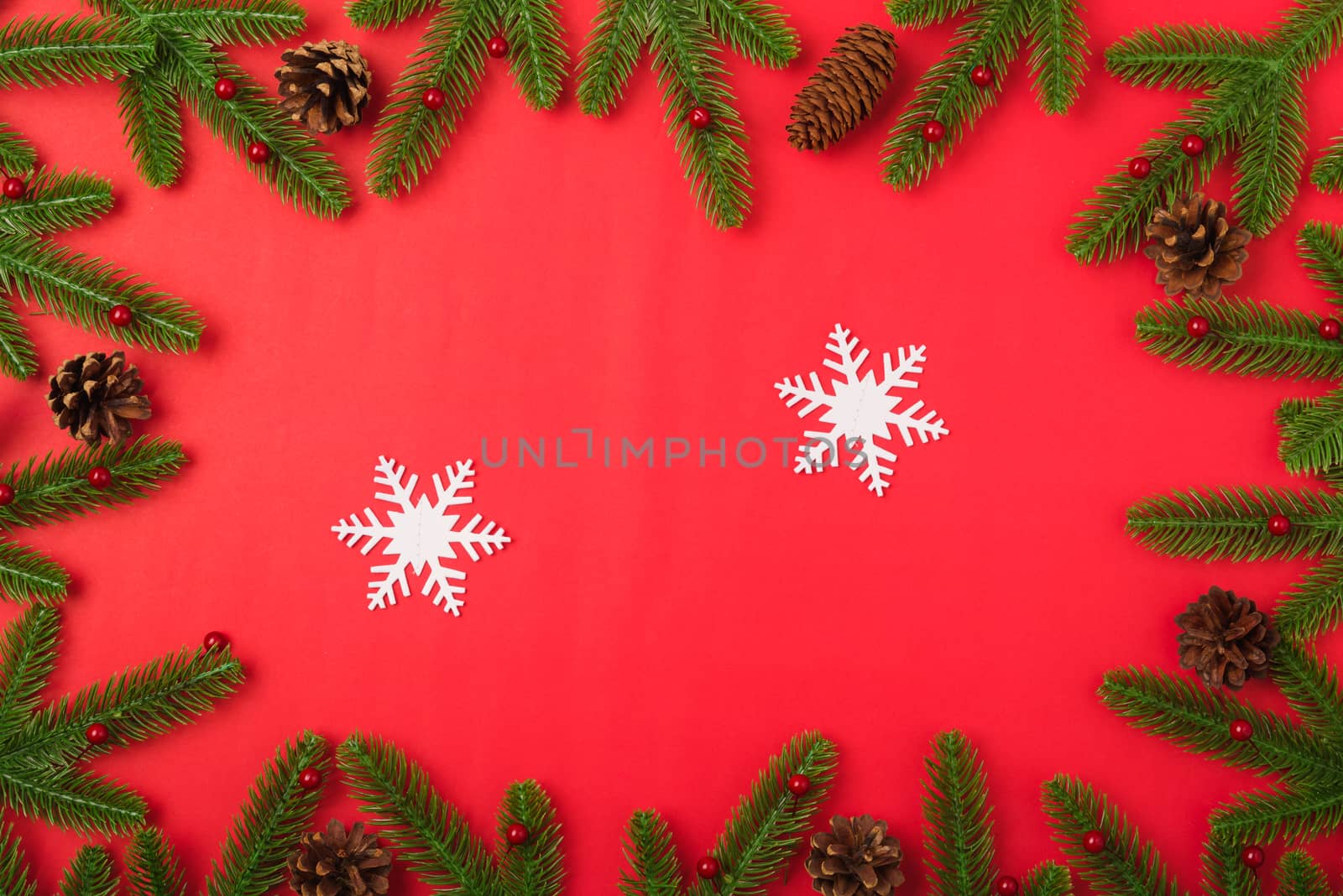 Happy new year or christmas day top view flat lay fir tree branches and decoration on red background with copy space for your text
