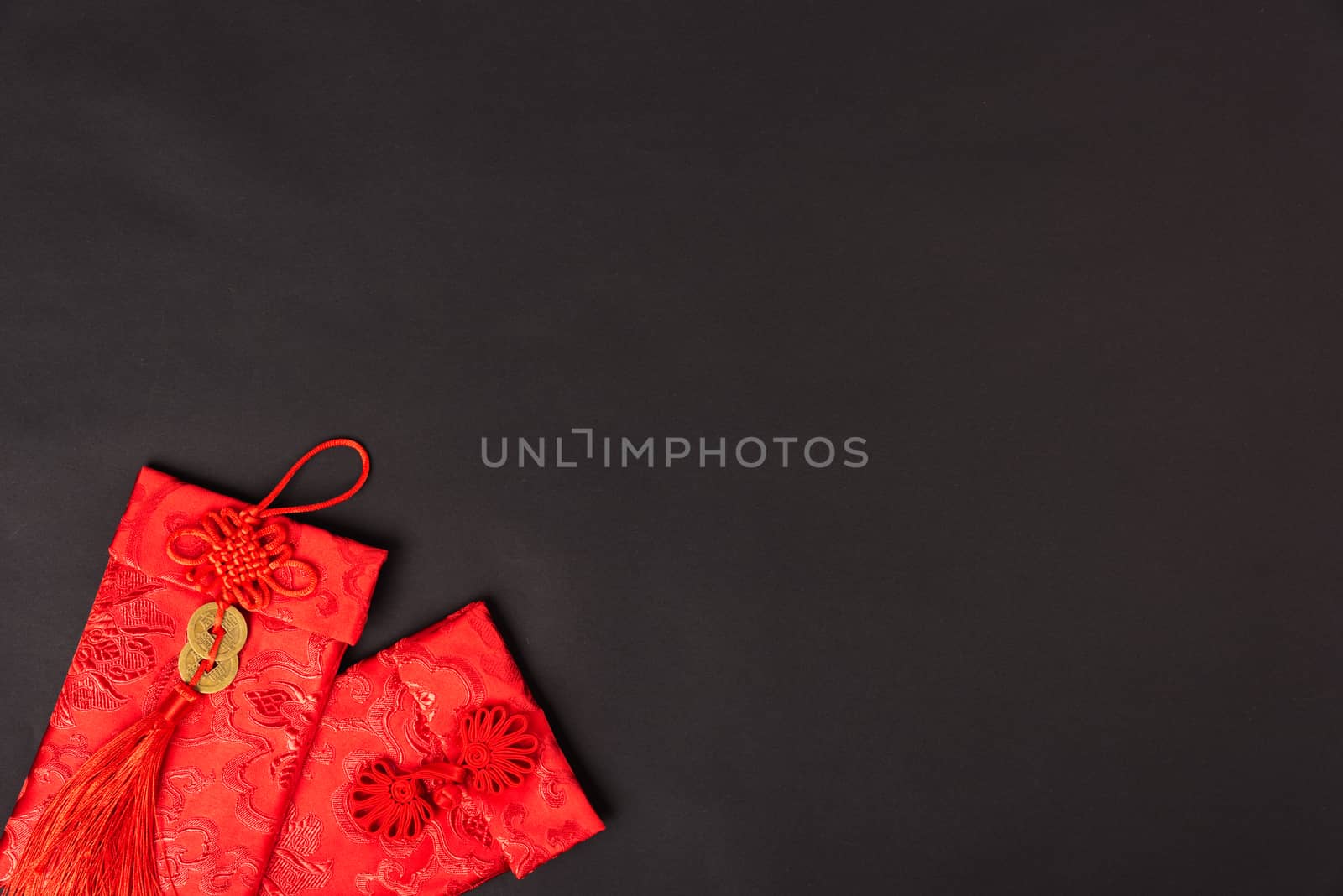 Chinese new year festival concept, flat lay top view, Happy Chinese new year with Red envelope (Character "FU" means fortune, blessing, wealth) on black background with copy space for your text