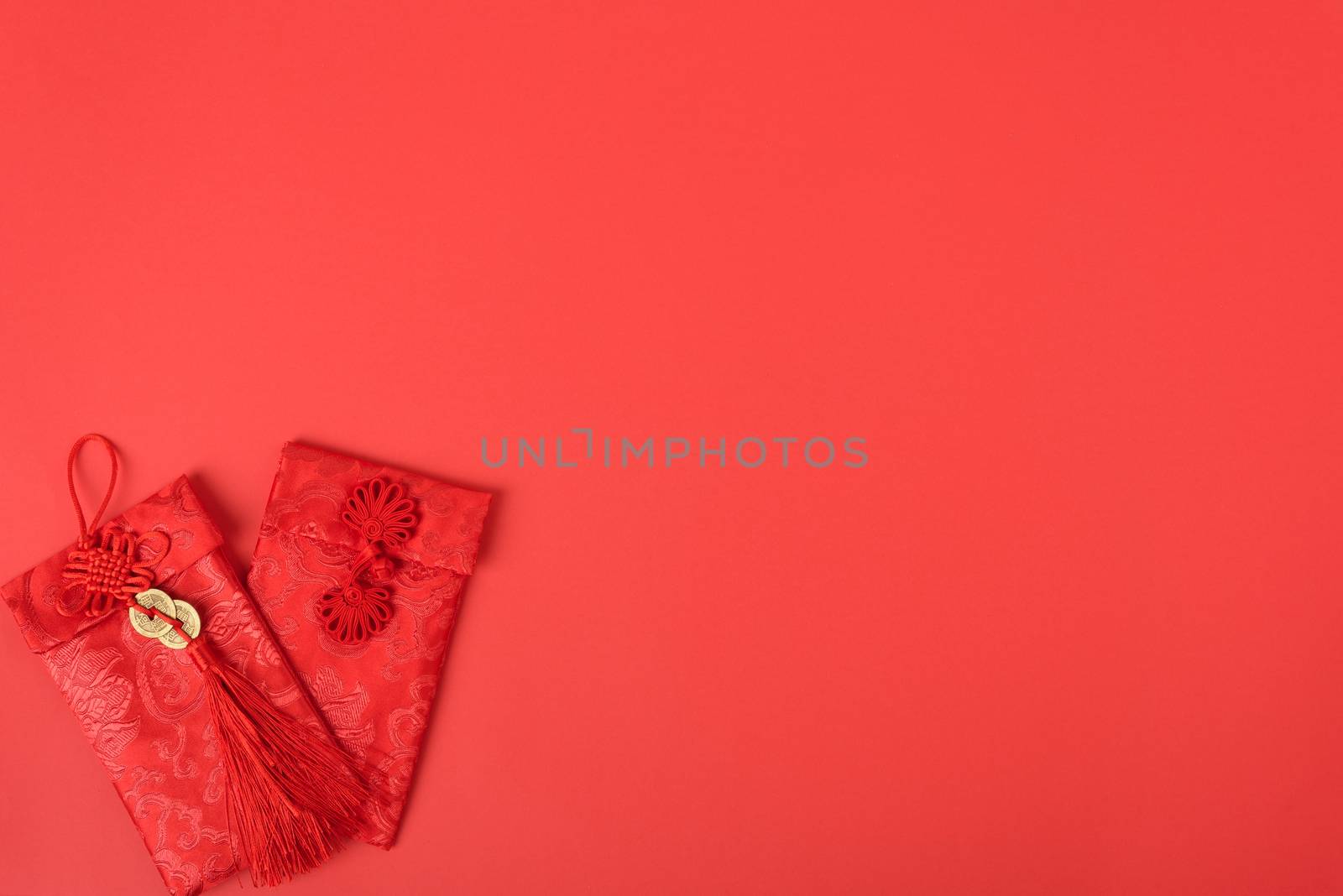 Chinese new year festival concept, flat lay top view, Happy Chinese new year with Red envelope (Character "FU" means fortune, blessing, wealth) on red background with copy space for your text