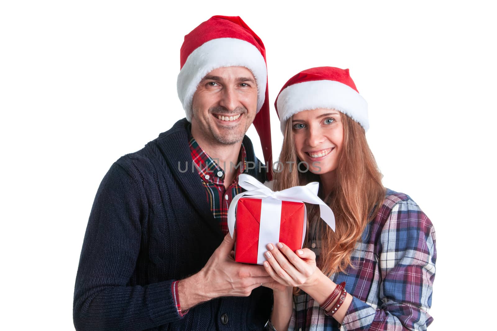 Happy beautiful couple holding christmas gift box isolated on white background