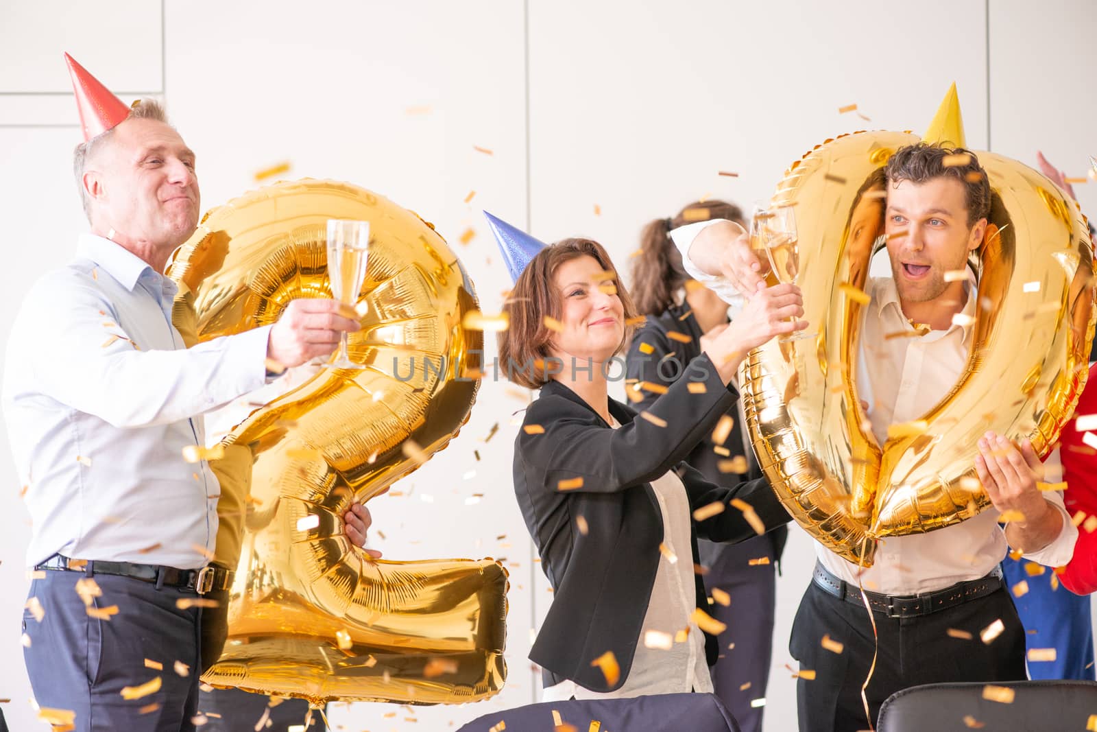 Business team of People Celebrating New Year in Modern Office. People Have Fun. Indoor Party. Celebrating of New Year.