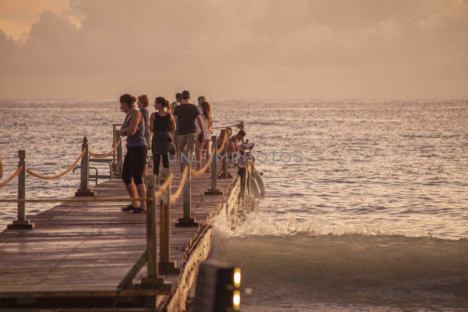 BAYAHIBE, DOMINICAN REPUBLIC 13 DECEMBER 2019: People on the pier at sunset