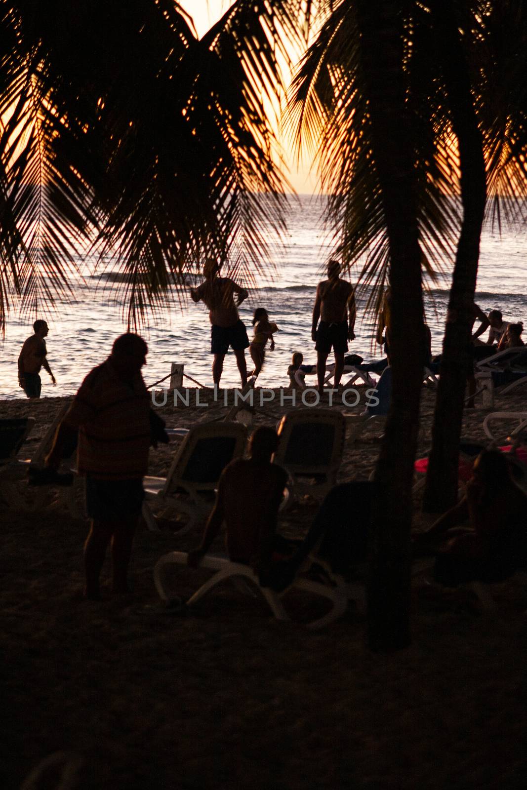 BAYAHIBE, DOMINICAN REPUBLIC 13 DECEMBER 2019: Silhouette of people on the beach at sunset