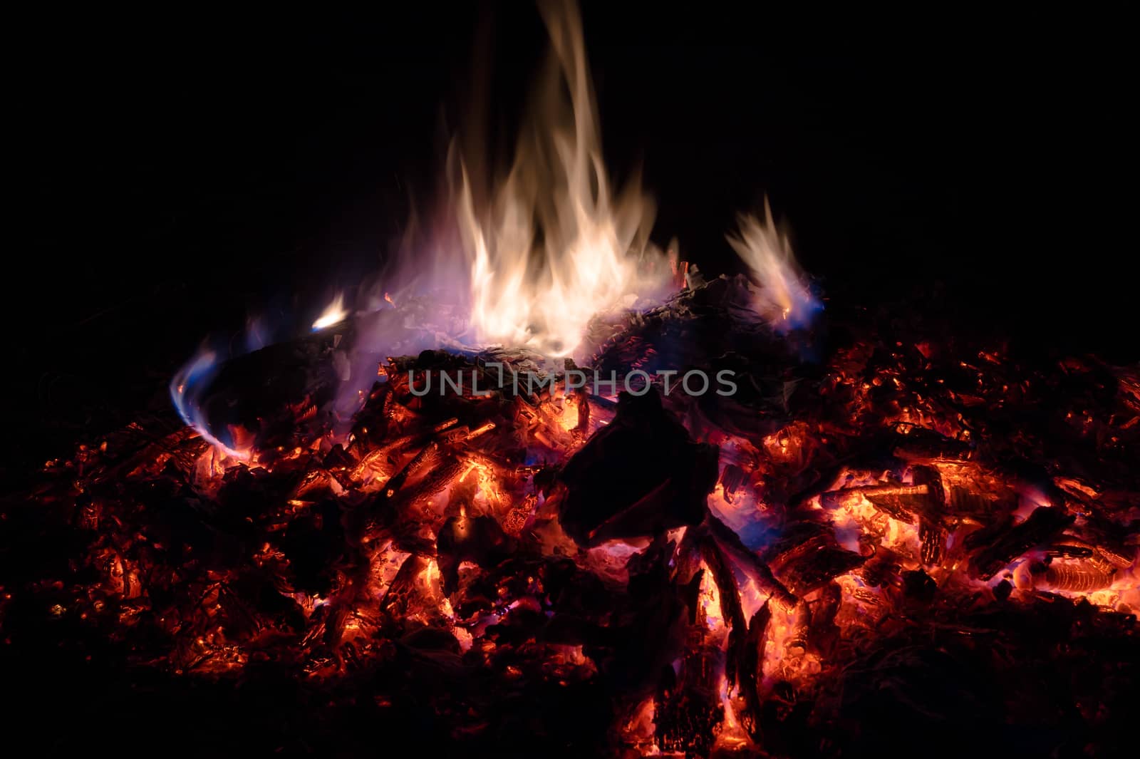 A low light long exposure photo of smouldering coals. by alexsdriver