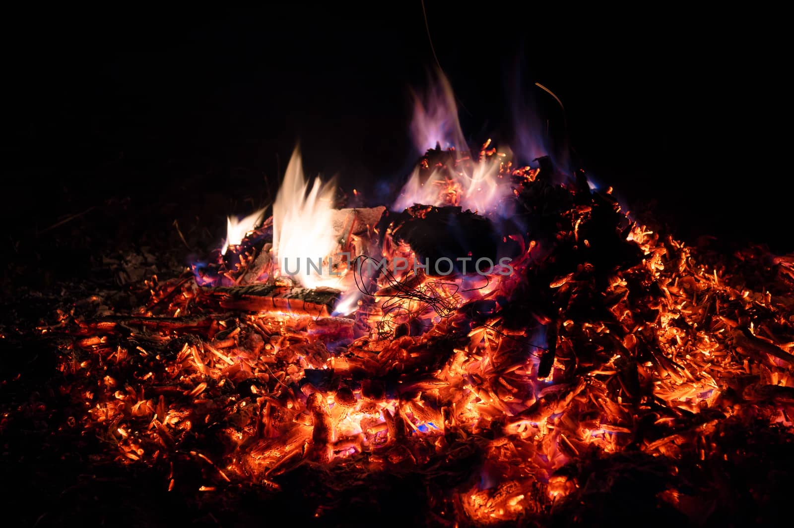 A low light long exposure photo of smouldering coals. by alexsdriver