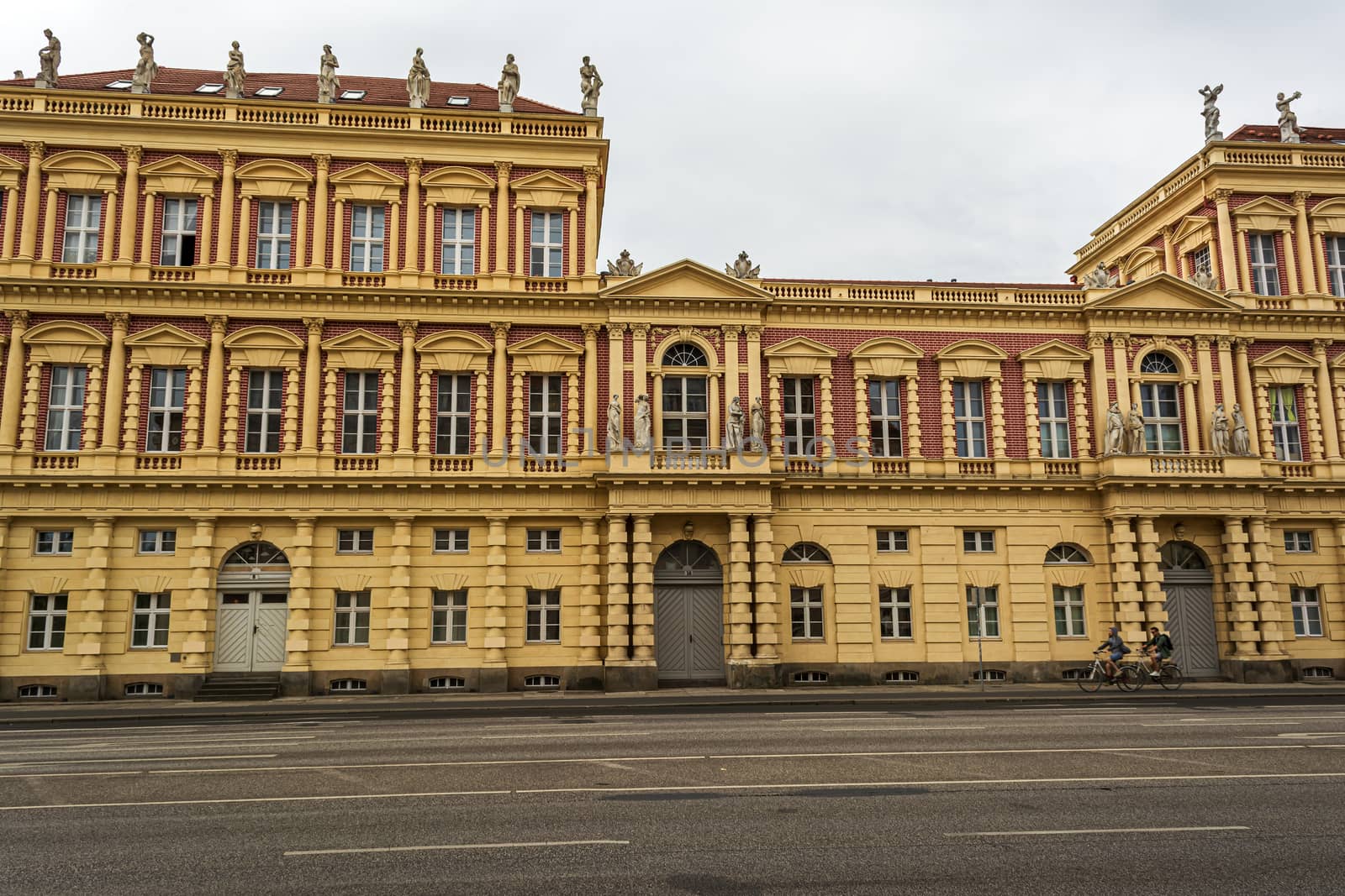 Berlin, Germany - August 17 2019 - View of historical building in Potsdam, Germany with two cyclists