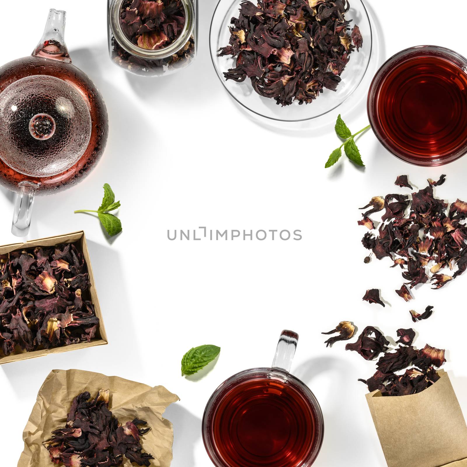 Hibiscus tea and beverage accessories on white background.