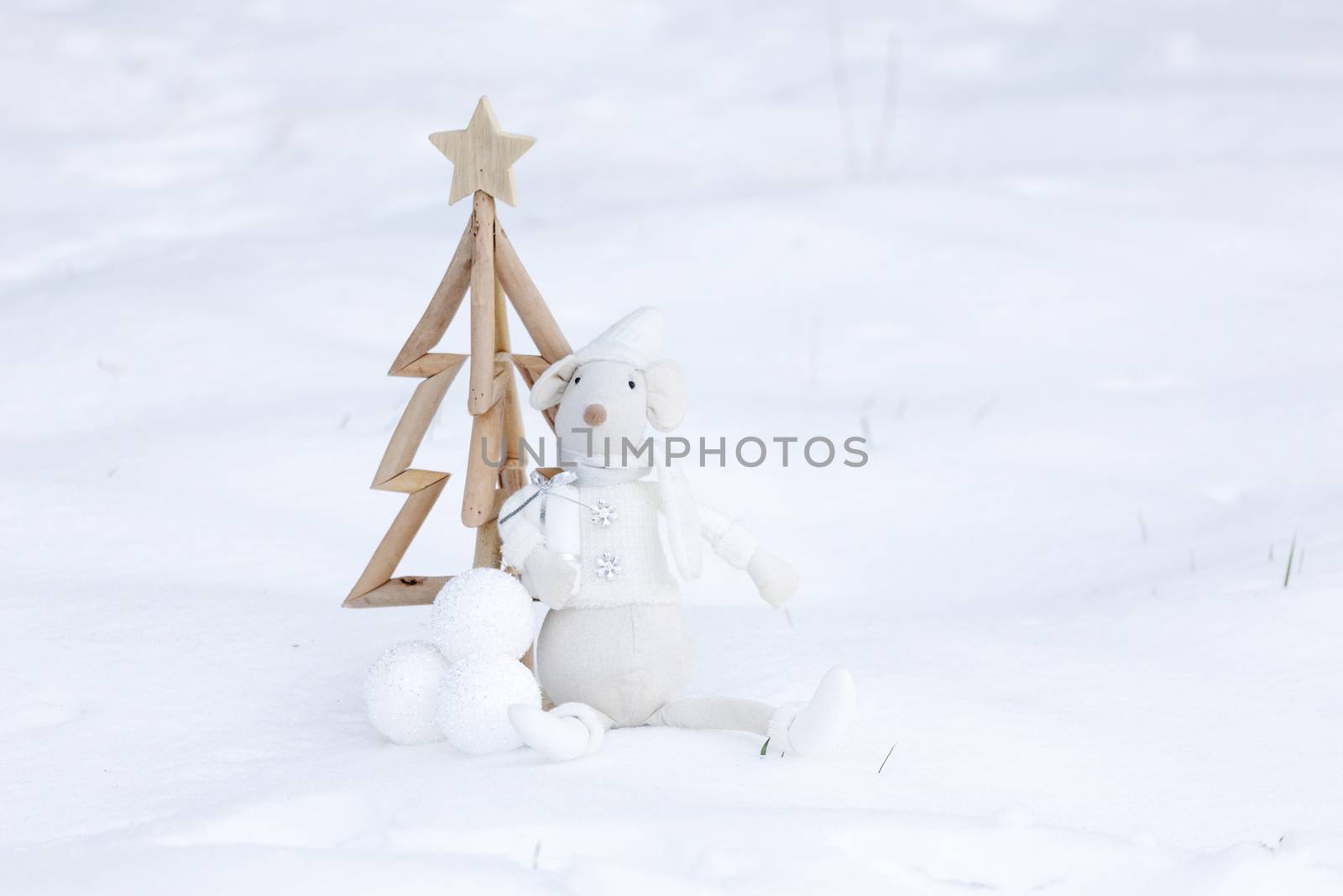 Simple Christmas tree, Christmas baubles and toy decoration carry present in fresh snow