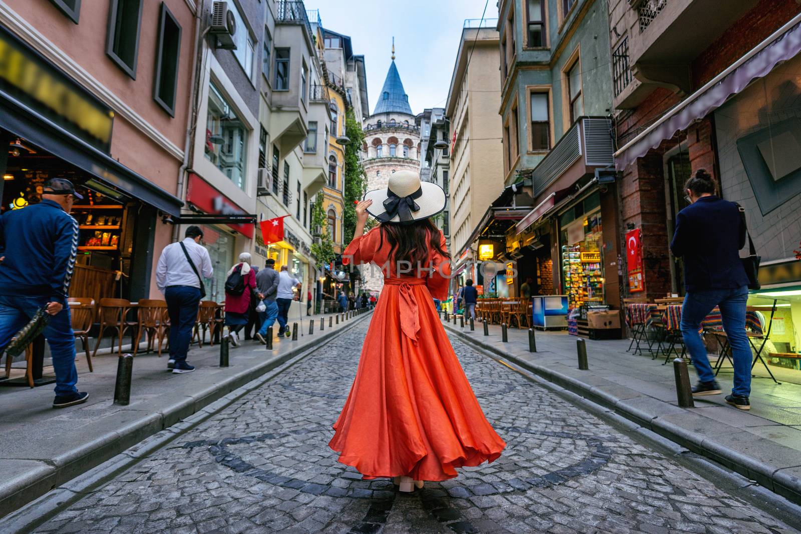 Woman standing at Galata tower in Istanbul, Turkey. by gutarphotoghaphy