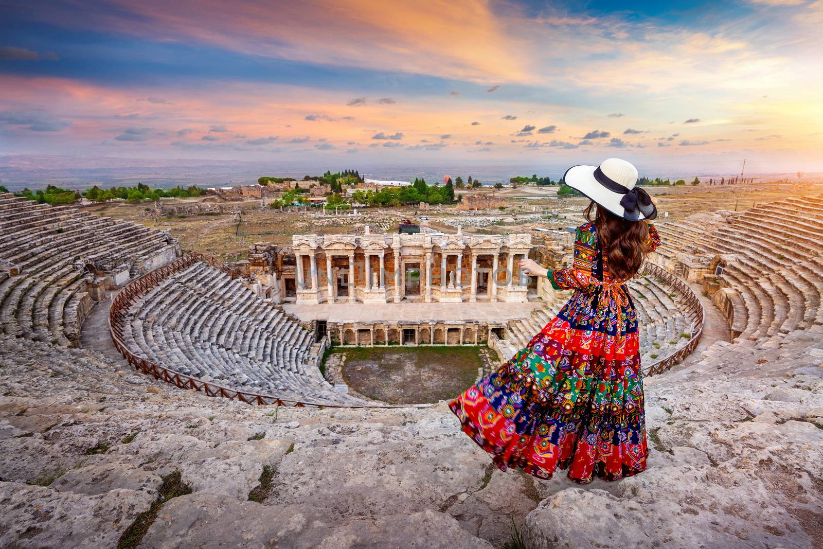 Woman standing on theater of Hierapolis ancient city in Pamukkale, Turkey. by gutarphotoghaphy