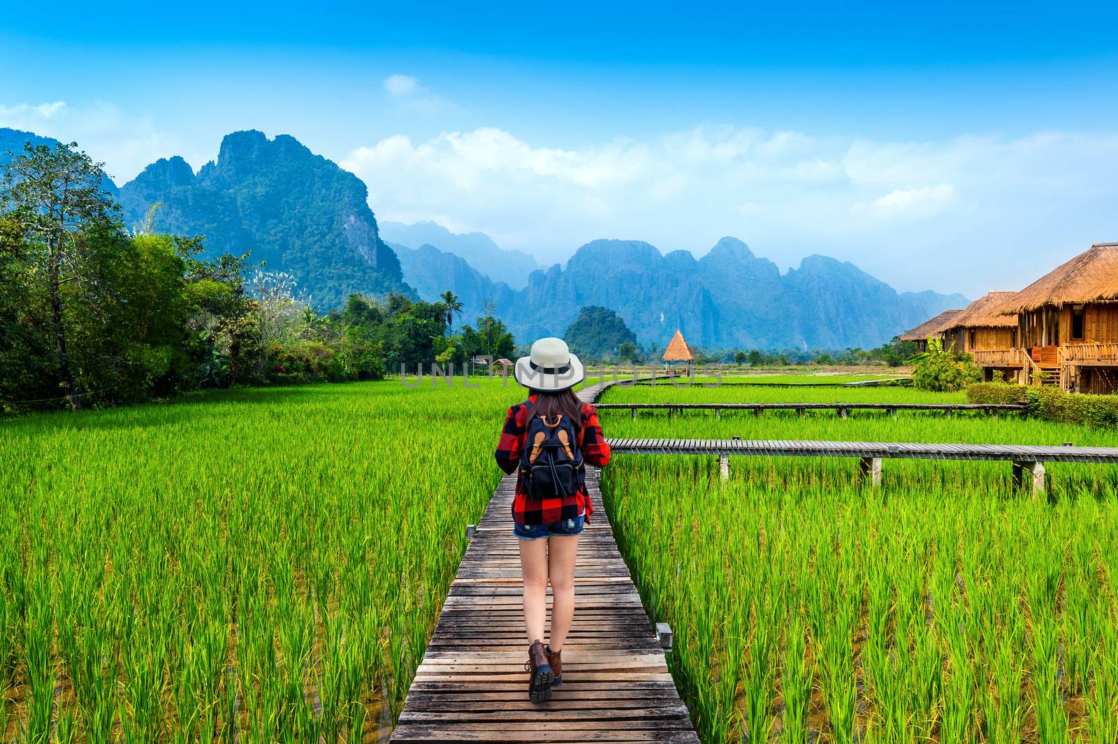 Tourism with backpack walking on wooden path, Vang vieng in Laos by gutarphotoghaphy