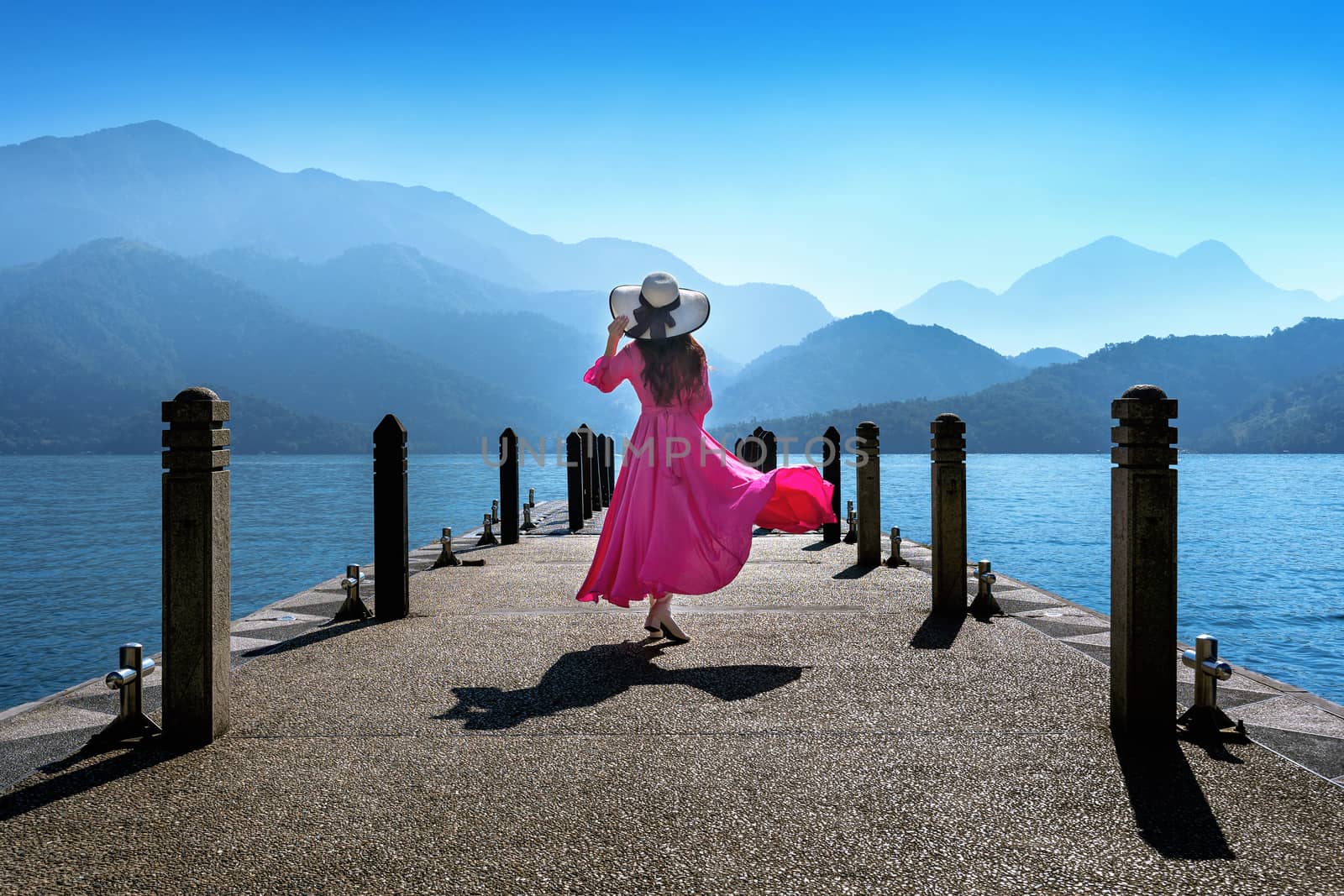 Beautiful girl walking at Sun Moon Lake in Taiwan.