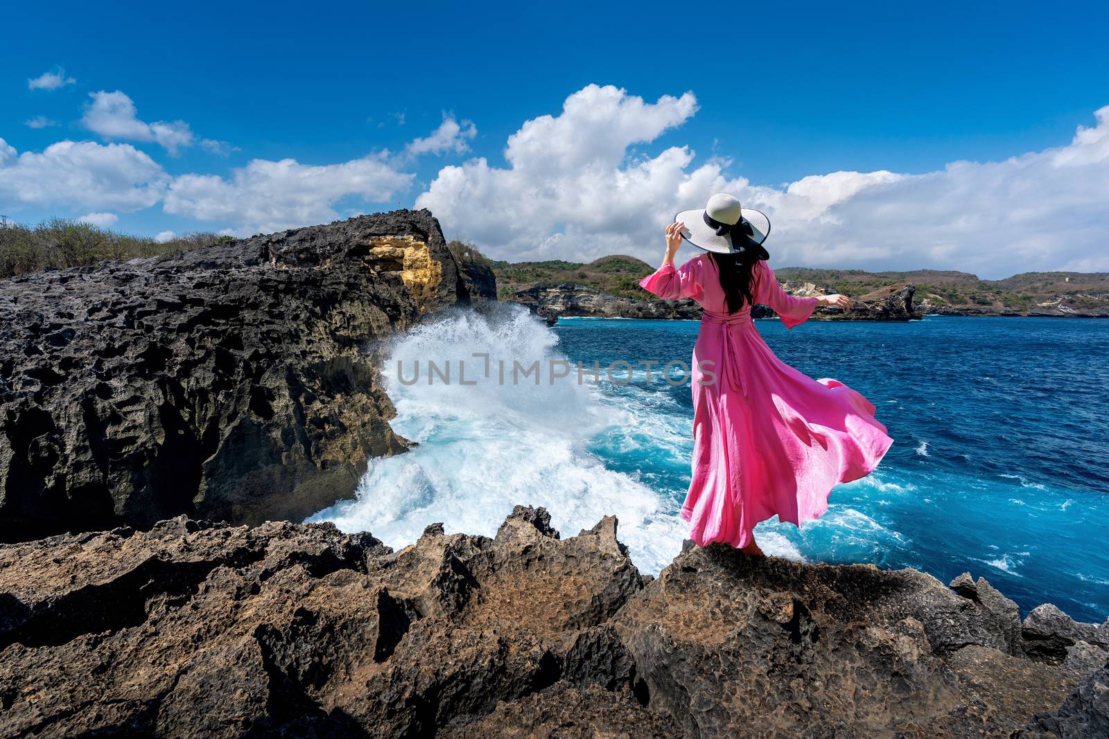 Beautiful girl standing on the rock at Angel's Billabong near Broken beach in Nusa penida island, Bali in Indonesia. by gutarphotoghaphy