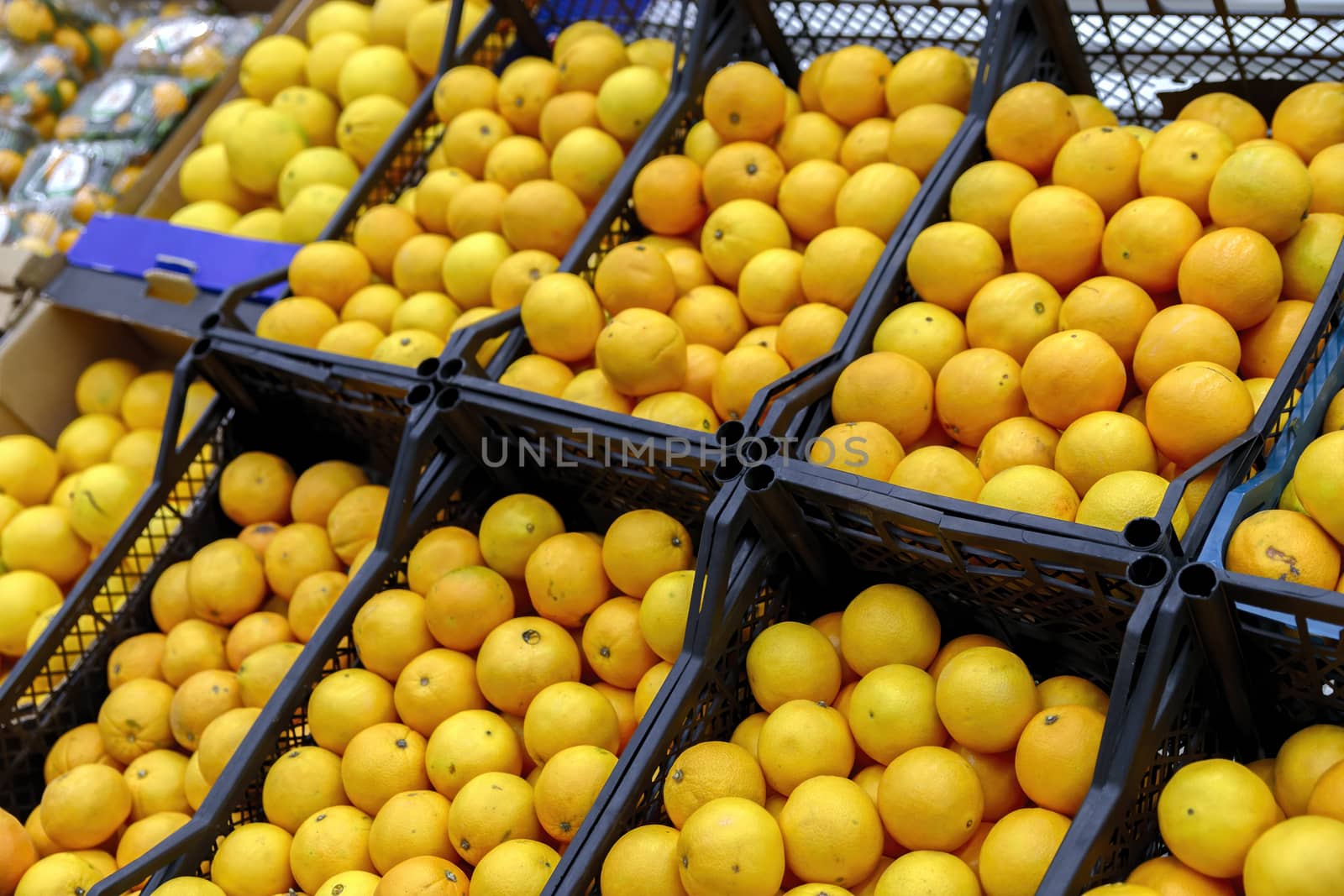 Close up view of madarines orange on the sheft in the supermarket. Healty and fresh fruits background in a supermarket super store.